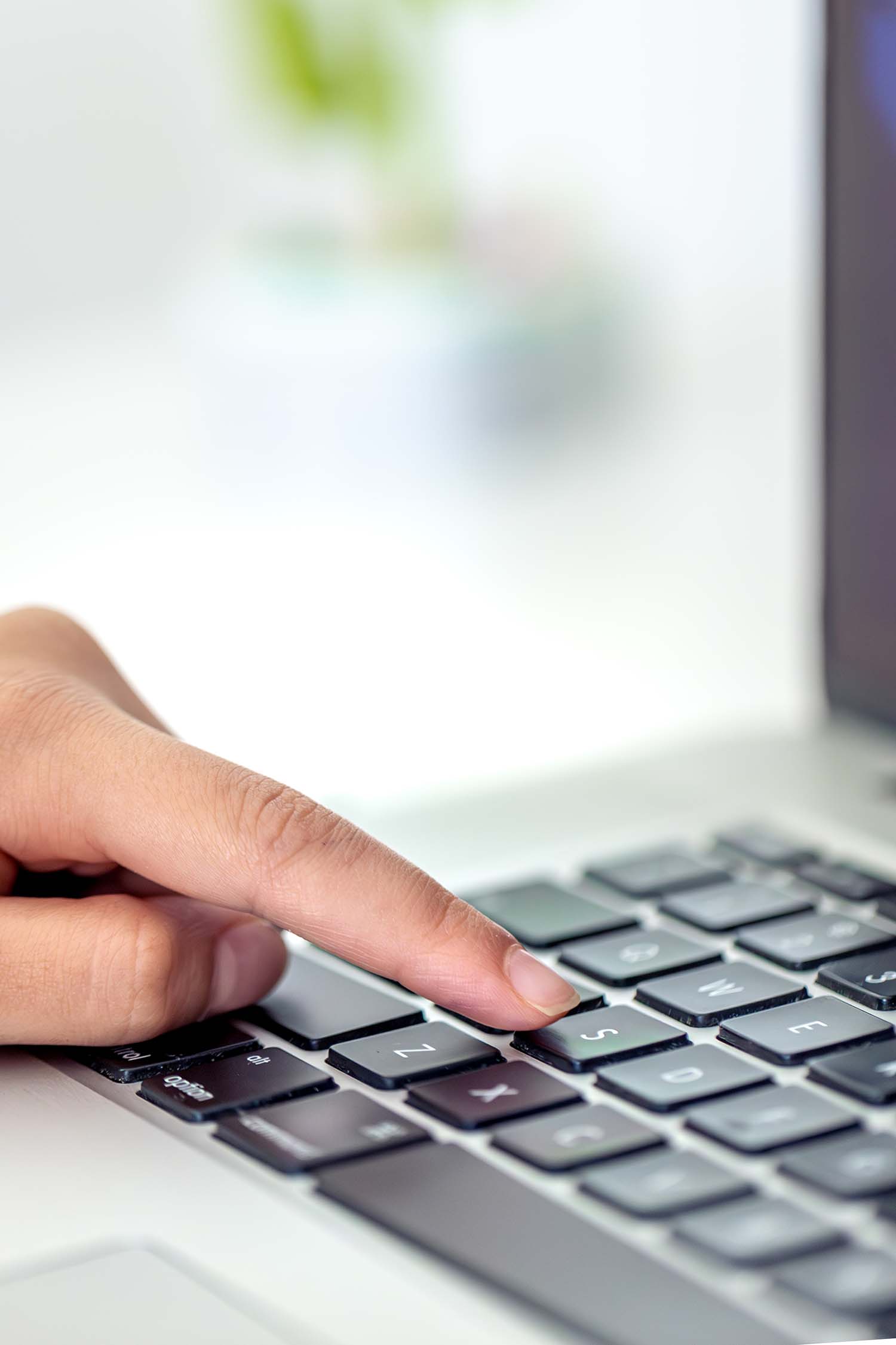 The girl is typing on the laptop keyboard. Girl's hands on the keyboard.